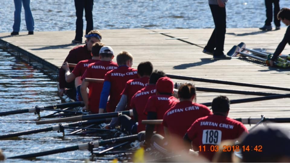 Team in boat at dock